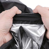 Hands holding a heavy-duty protective cover for a lawn mower, showing the silver inner layer.