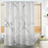 White shower curtain with black marble veining hanging in a bathroom
