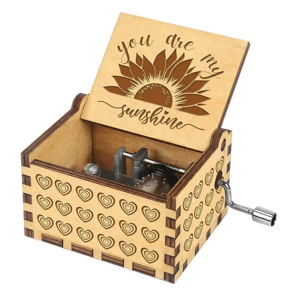 A small wooden music box with a lid featuring a sunflower design and a decorative patterned base.