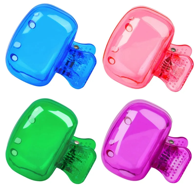 Three colored silicone toothbrush head covers in blue, pink, and green.