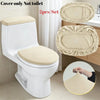 A white toilet seat with two beige velvet protectors shown next to the toilet.