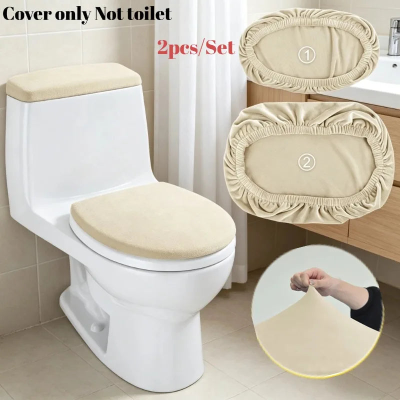 A white toilet seat with two beige velvet protectors shown next to the toilet.