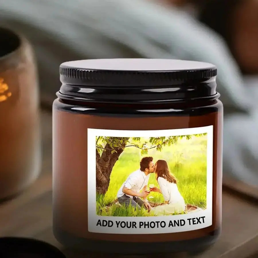 A dark brown glass jar with a black lid containing a candle, featuring a photo space for customization.