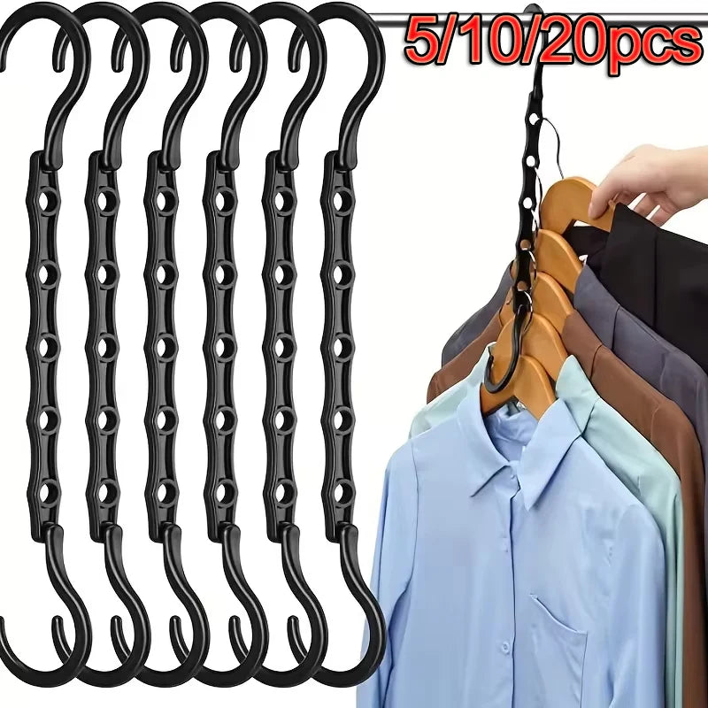 A multi-pack of black plastic clothes hangers and a wooden hanger are shown for closet organization.