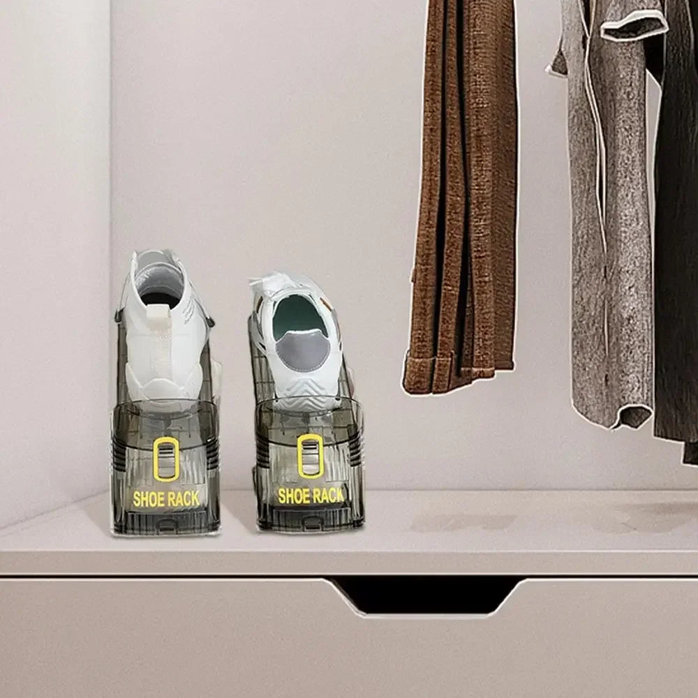 A pair of clear plastic shoe racks with white shoes are displayed on a shelf next to a hanging garment.