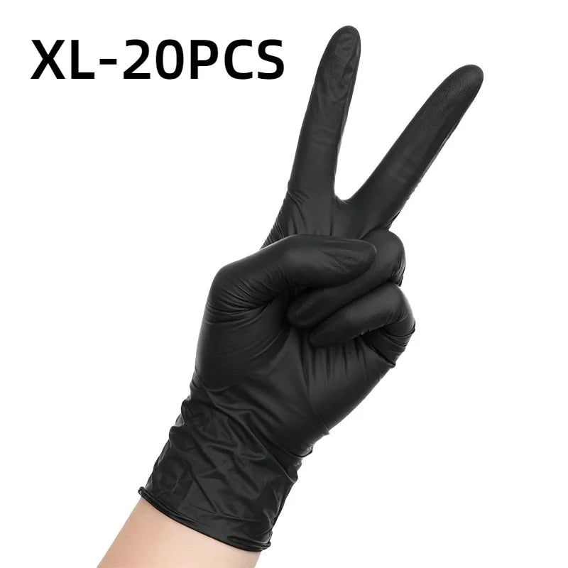 A hand wearing black nitrile disposable gloves making a peace sign.