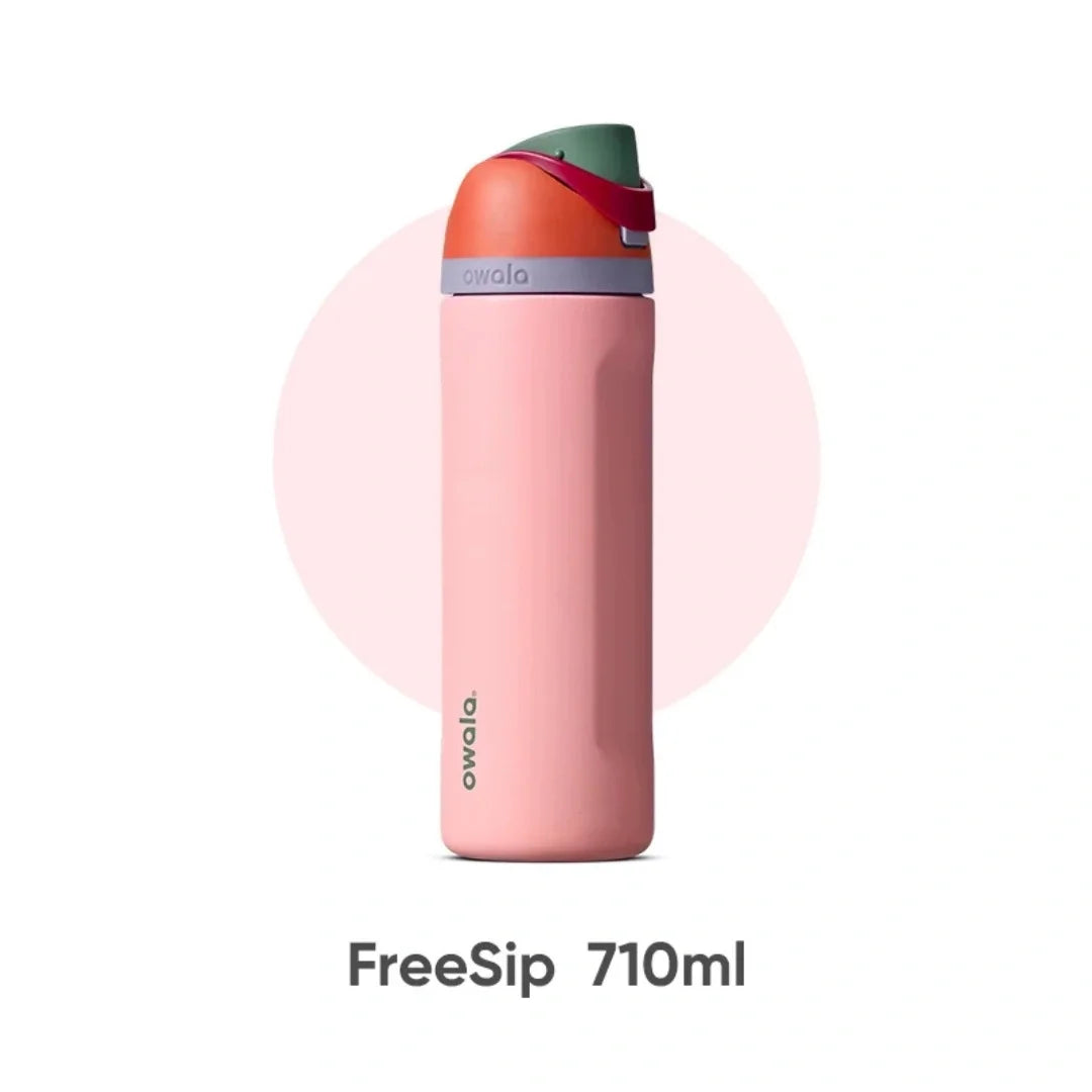 A pink insulated water bottle with a green cap and straw, labeled FreeSip 710ml.