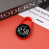 A red digital LED hanging pocket watch displaying 12:58 on a pink surface.