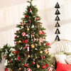 A decorated Christmas tree adorned with red and gold ornaments and silver ribbons.