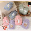 A collection of plush cartoon hot water bottles featuring animals like a cat, rabbit, and bear in various pastel colors.