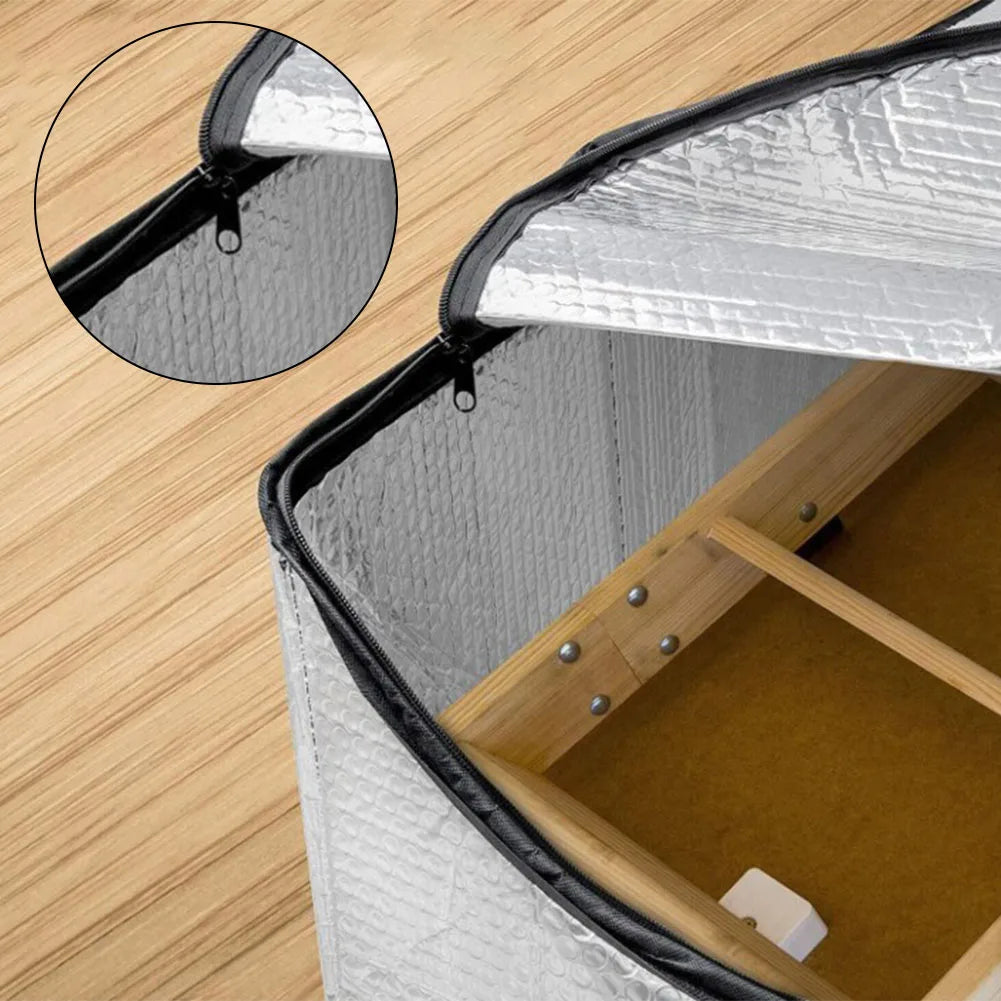 Close-up view of an attic heat and dust barrier with a zippered opening showing the interior.
