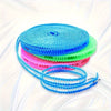 A stack of colorful heavy-duty portable clothesline ropes in blue, cyan, green, and pink.