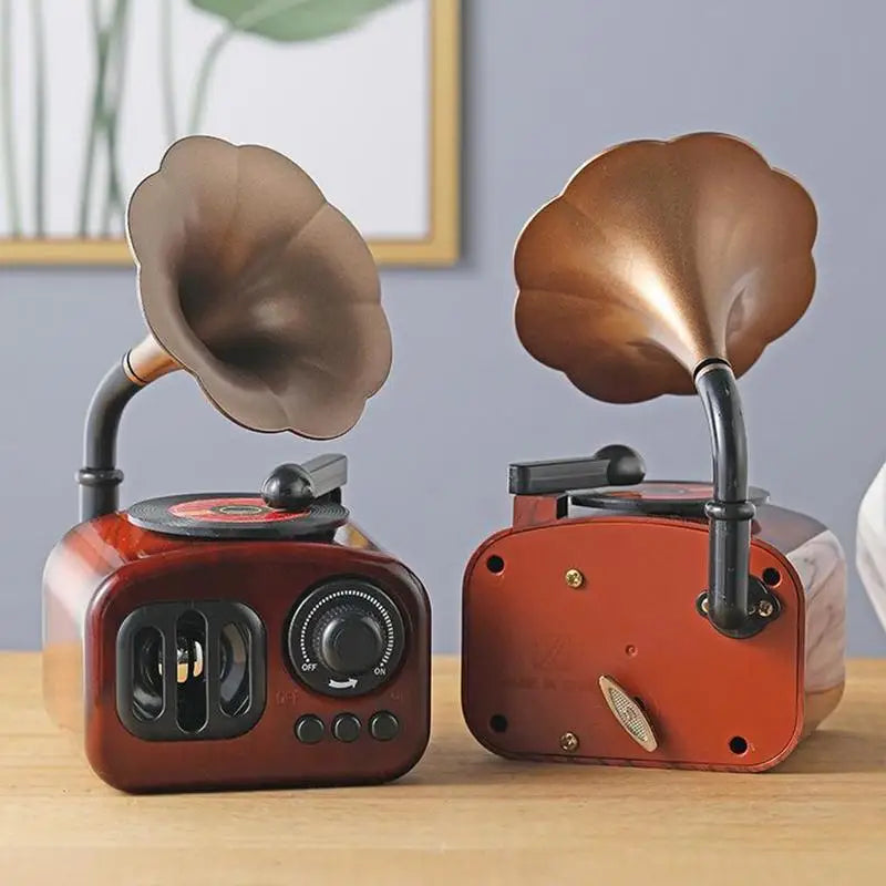 A pair of retro phonograph music box decor items featuring bronze-colored horns and wooden bodies.