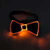 A pair of orange LED light up anime glasses glowing brightly against a dark background.