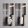 A hand inserts a wall-mounted toilet brush handle into its holder, demonstrating the automatic opening and closing mechanism.