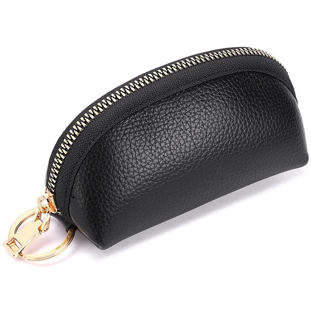 Black leather key organizer wallet with a gold zipper closure shown from the side.