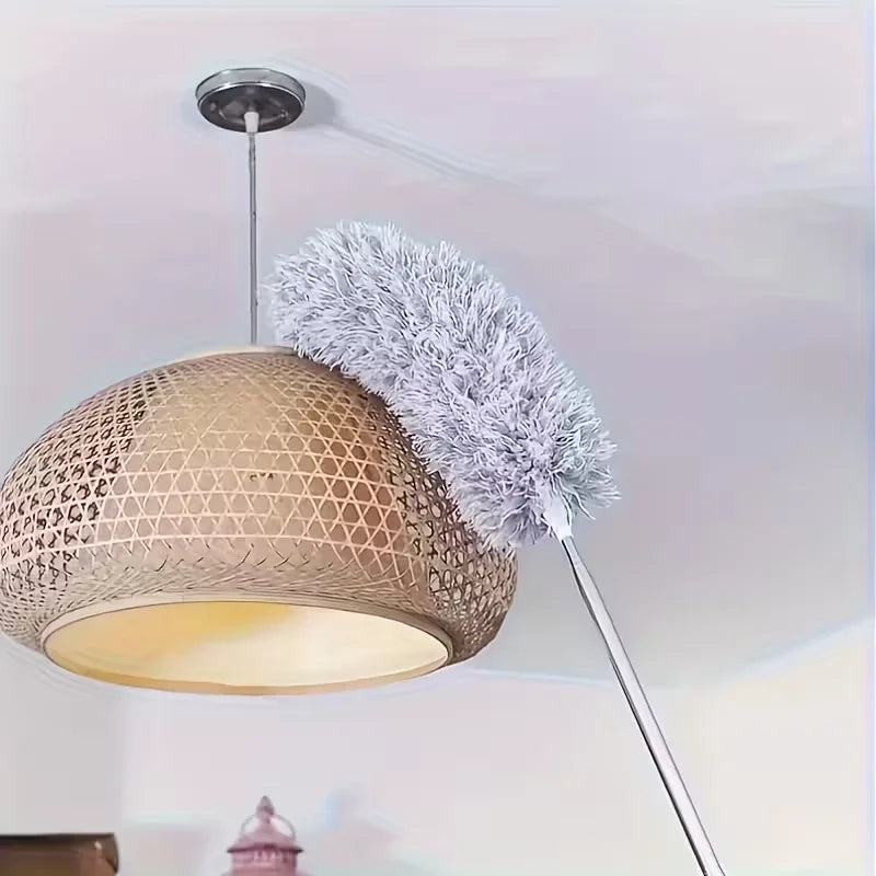 A modern pendant light featuring a woven gold shade and a fluffy gray microfiber duster with an extension rod.