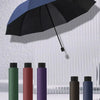 A collection of extra large windproof folding umbrellas in various colors, including black, green, maroon, and purple.
