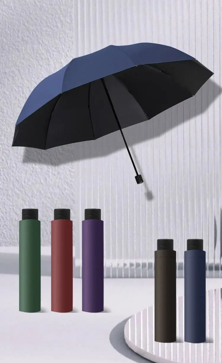 A collection of extra large windproof folding umbrellas in various colors, including black, green, maroon, and purple.
