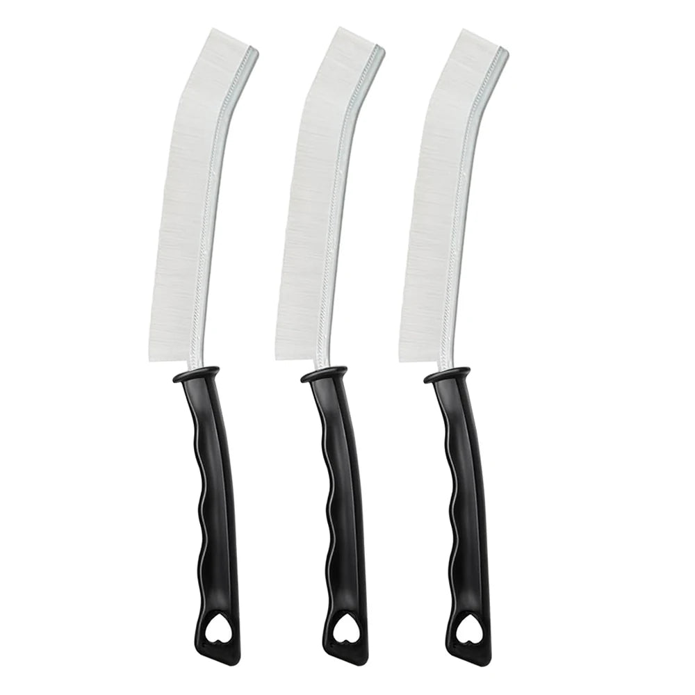 A set of three white crevice cleaning brushes with black handles.