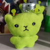 A bright lime green plush cat with yellow ears is shown, likely a keychain or plush toy.