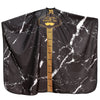Black satin hair cutting cape with a gold logo and marble pattern