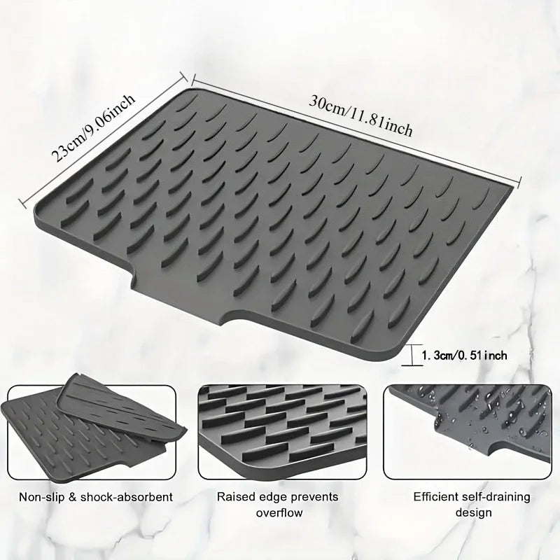 A gray silicone dish drying mat featuring raised drainage ridges and a non-slip surface.