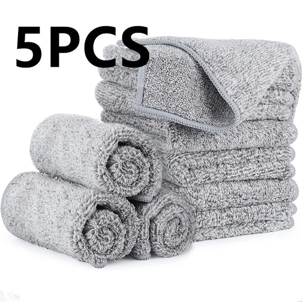 A stack of five gray eco-friendly bamboo microfiber kitchen towels rolled up.