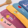 A collection of colorful soft absorbent hair towels featuring various designs like strawberries, avocados, lemons, and stars.