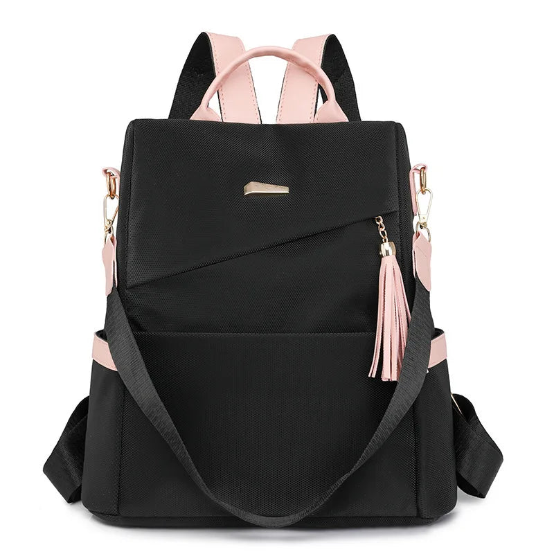 Black women's anti-theft PU leather travel backpack with pink accents and tassel details