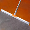 A silicone squeegee broom with an aluminum handle is shown cleaning a dark surface against an orange background.