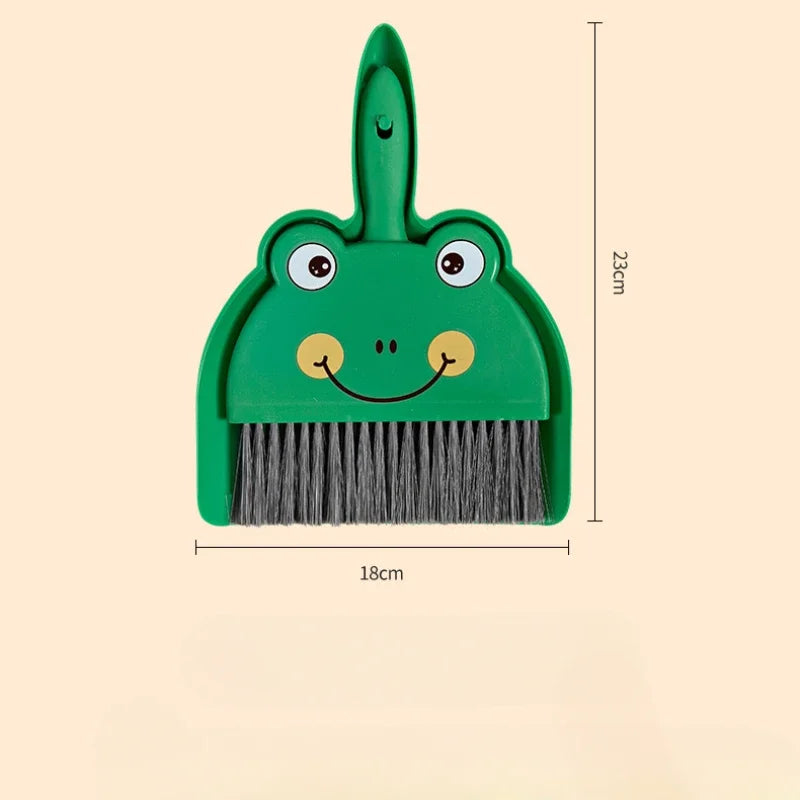 A green cartoon animal broom and dustpan set with a brush and a pan.