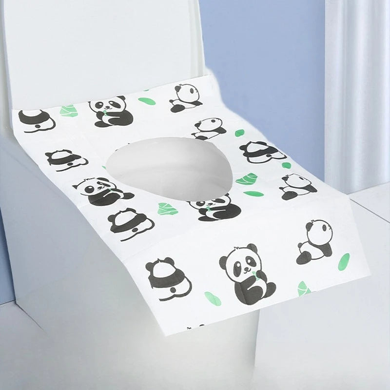 A white disposable printing seat cover featuring a pattern of black panda illustrations on a light blue background.