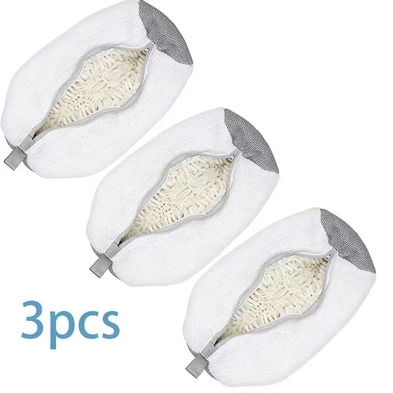 Three white reusable shoe washing bags with an invisible zipper and light yellow padding