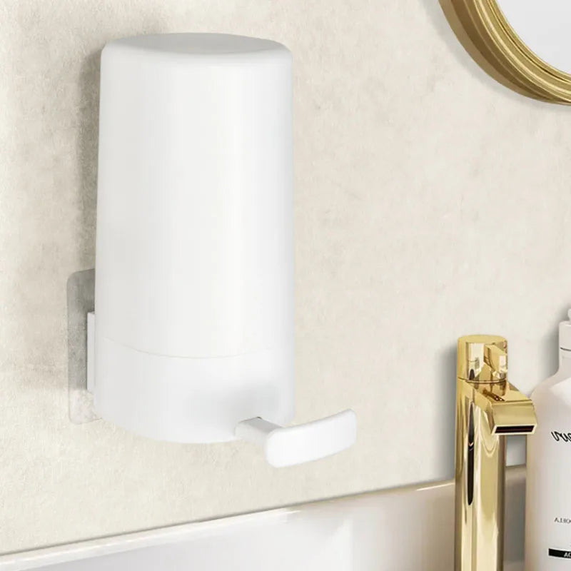 A white portable soap bar grinder with a wall-mount design attached to a light beige wall.