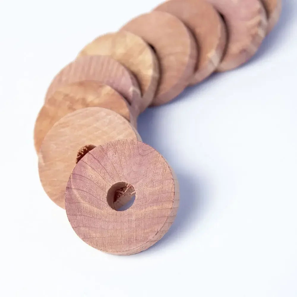 A stack of natural cedar wood blocks used as a pest deterrent.