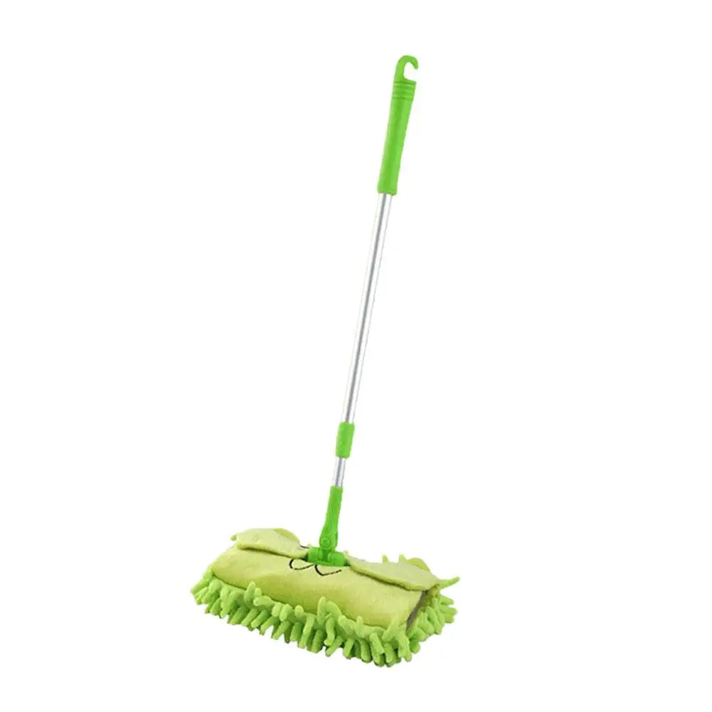 A green toddler mini broom and dustpan set with a handle and brush.