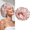 A pink floral satin-lined shower cap being worn by a woman.