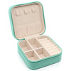 A light mint green portable PU leather jewelry storage box with a hinged lid and divided compartments.