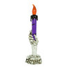 A skeleton hand sculpture holding a purple candle with an orange flame.