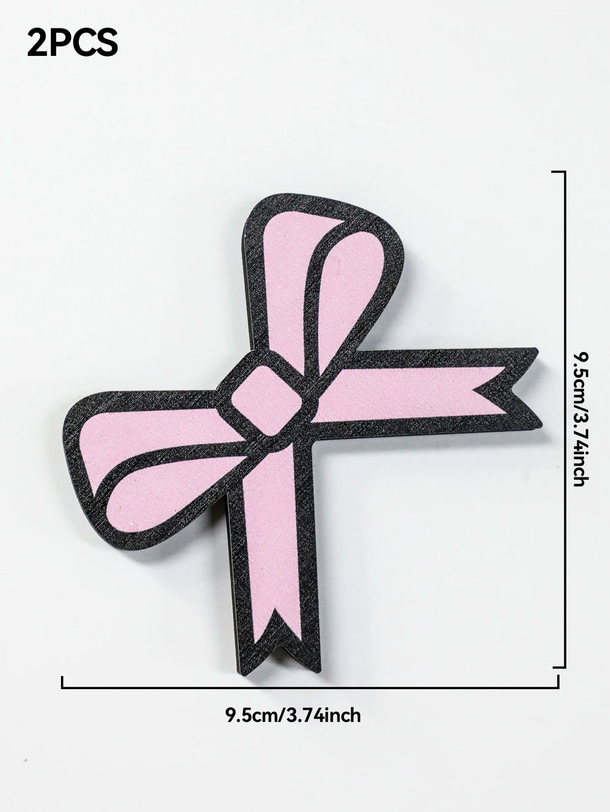 Deux décorations en forme de ruban rose avec un design d'oreille de chat sur fond blanc.