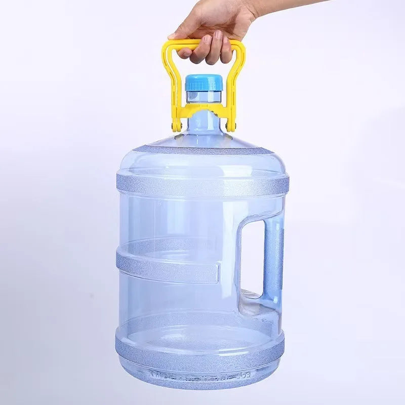 A hand is holding a clear blue water bottle carrier with a yellow handle and a blue cap.
