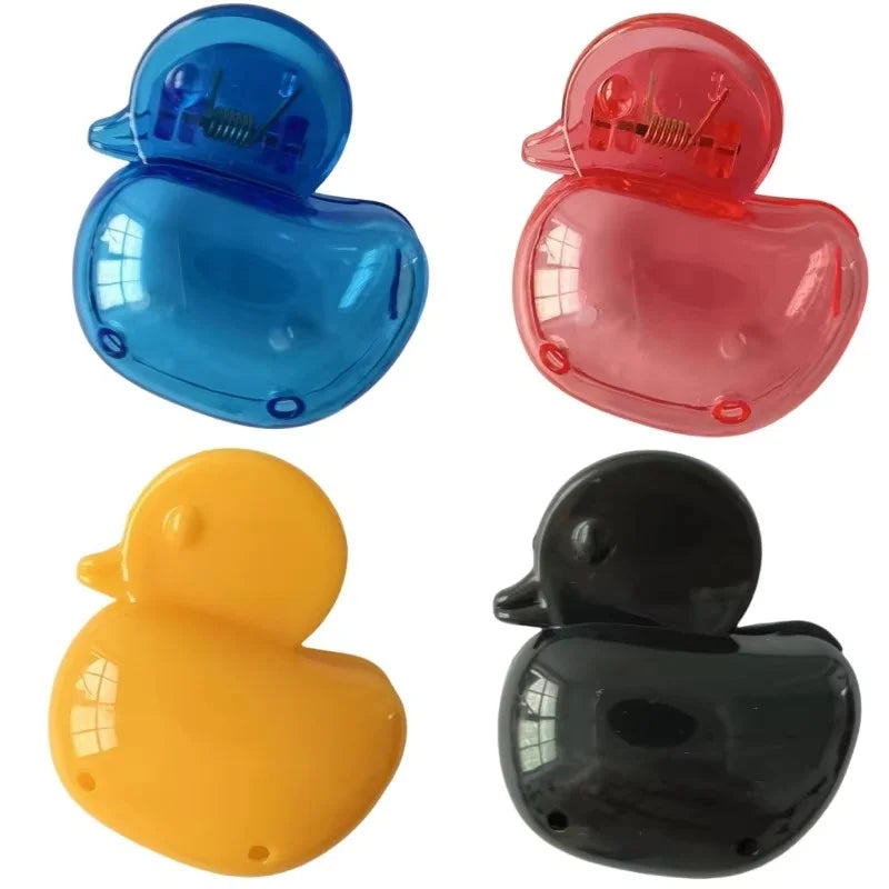 A set of four silicone toothbrush head covers or protectors in blue, pink, yellow, and black.