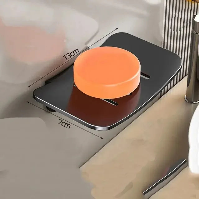 A wall mounted U-shaped soap dish organizer with an orange soap holder and a brown base.
