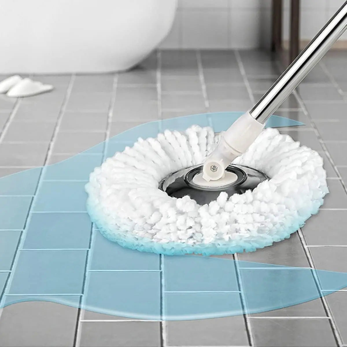 A white replacement microfiber spin mop head is shown on a blue cleaning mat with a silver handle.