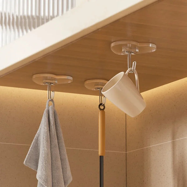 A kitchen or bathroom ceiling mount featuring a transparent heart-shaped adhesive hook and a hanging dishcloth.
