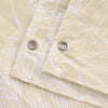 Close-up of a beige tropical sea life patterned shower curtain fabric with silver grommets.
