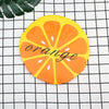 A bright orange citrus slice design on a yellow background used as a reusable fruit shower cap.