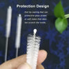A hand holds a white stainless steel straw cleaning brush with a protective design for cleaning straws and tubes.