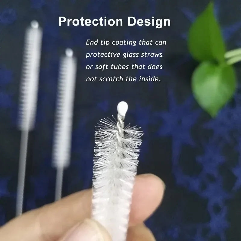 A hand holds a white stainless steel straw cleaning brush with a protective design for cleaning straws and tubes.